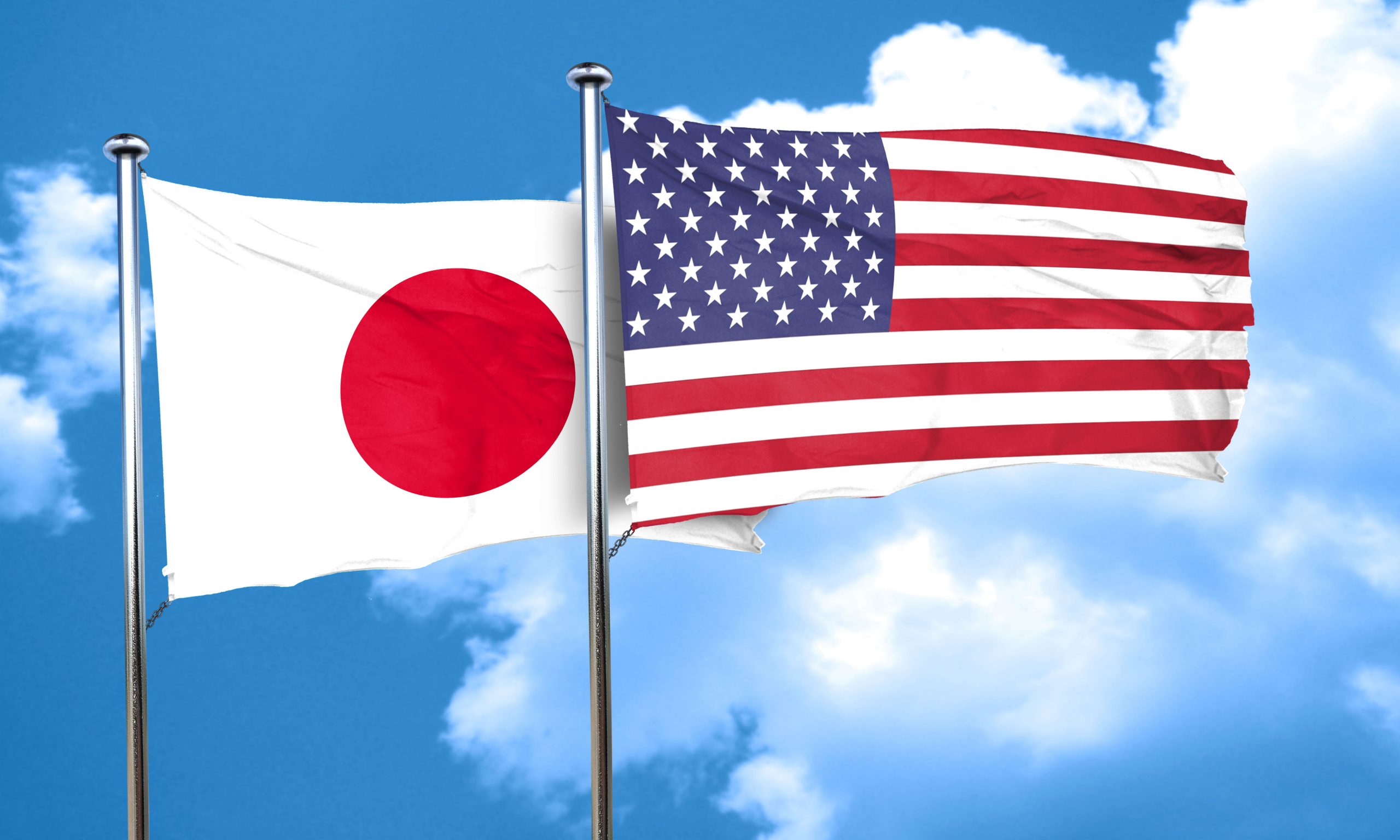US and Japan Flags waving in air