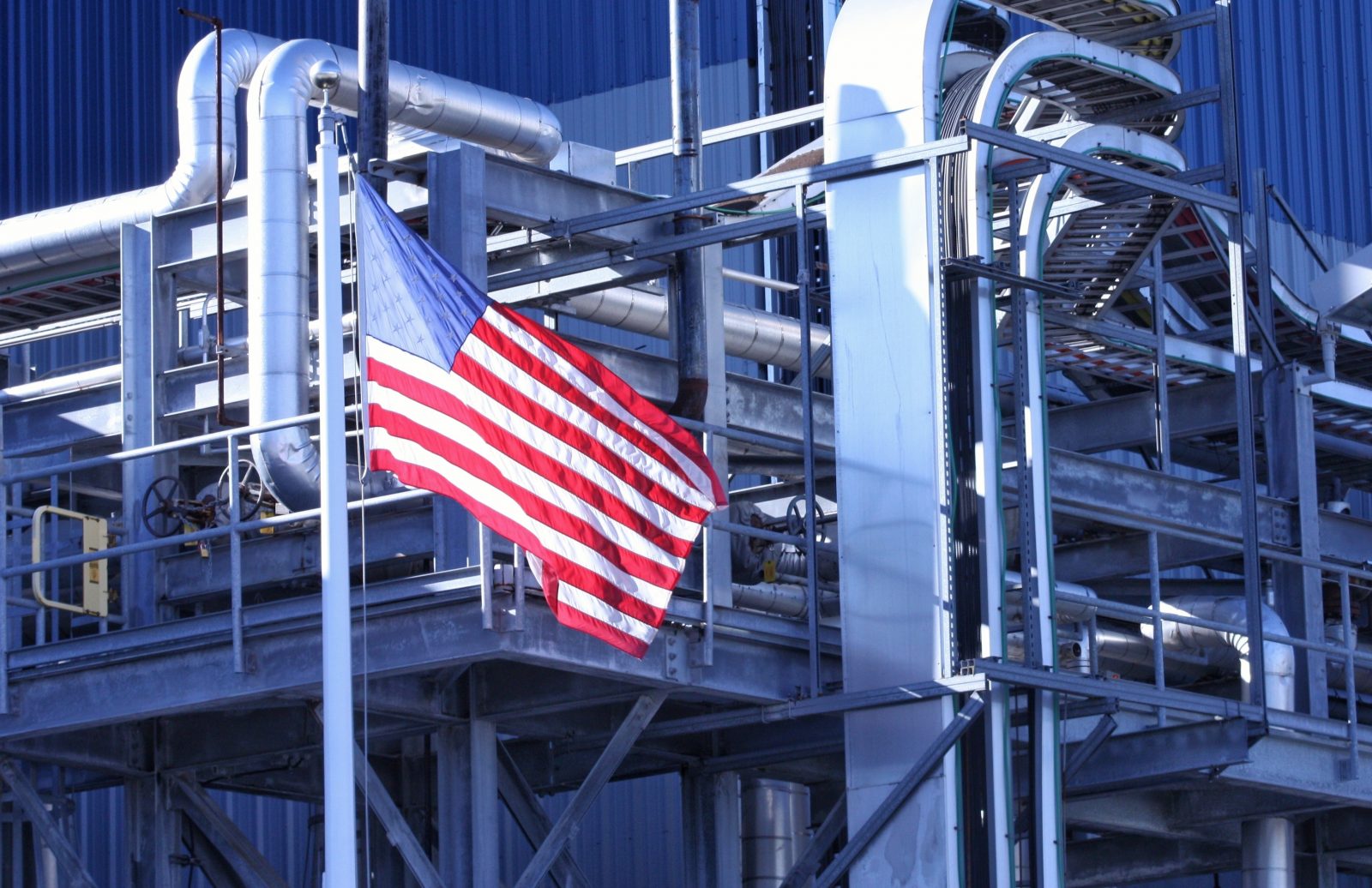 U.S. flag waves in front of an American manufacturing facility.