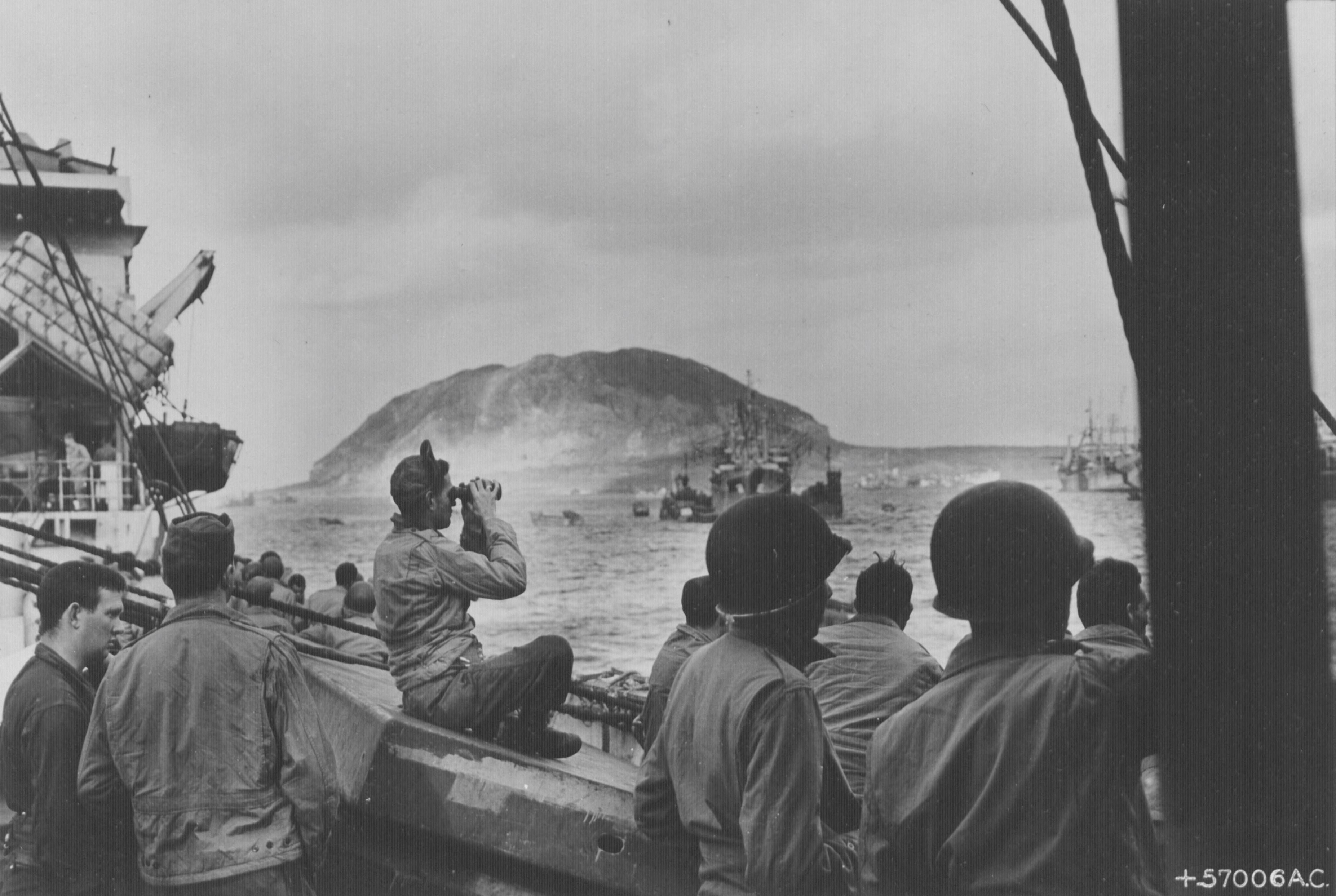 Marines aboard their ship watch events unfold on Iwo Jima, Feb. 20, 1945. National Archives and Records Administration, 204982564