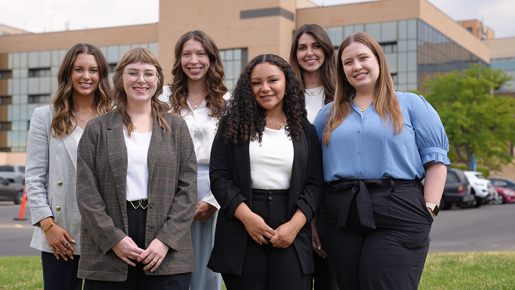 The six FY25 pharmacy residents pose in front of the George E. Wahlen VA Medical Center.