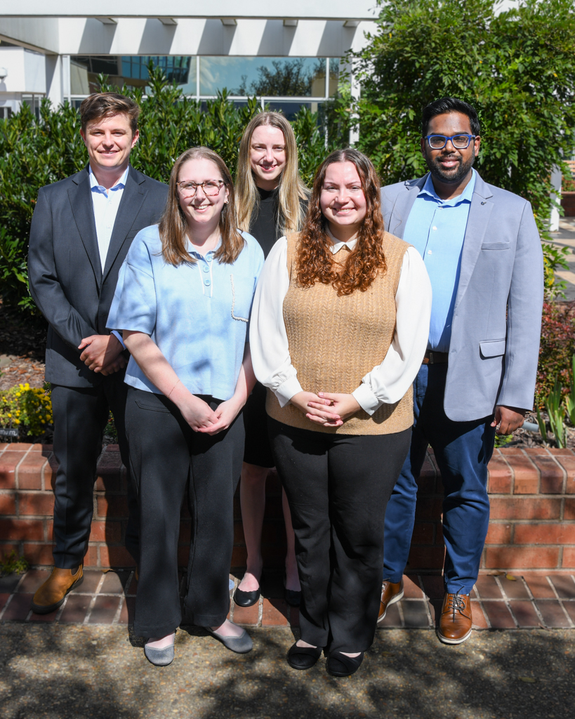 2 Men and 3 women standing posing for a photo 