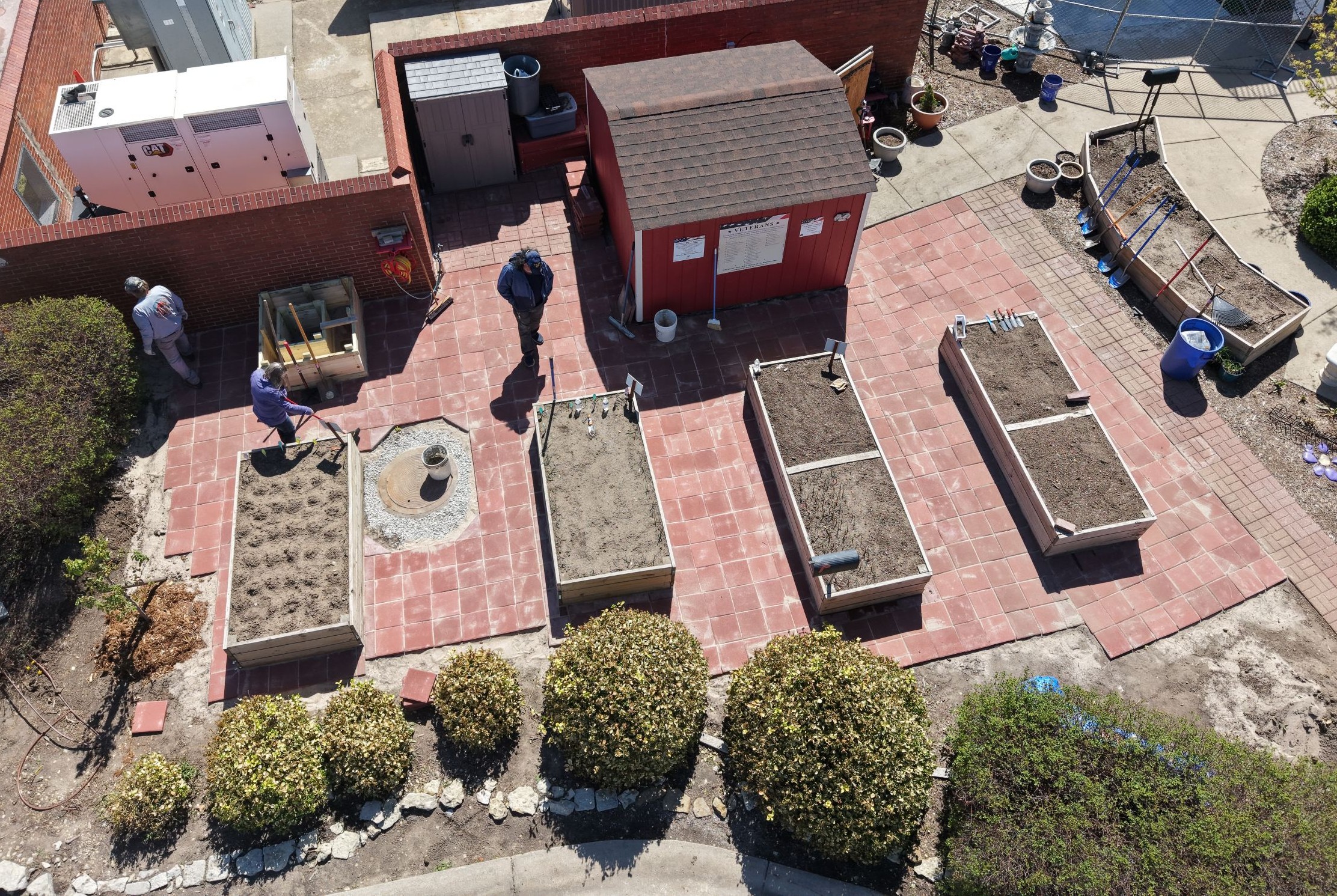 aerial view of the 2026 project that added red brick tiles around the raised garden beds, expanding areas of the garden accessible to those with mobility challenges.
