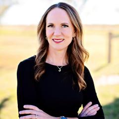 Jennifer Bird in a black, long sleeve shirt with her arms crossed.