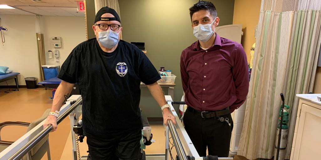 Two men standing in rehab room