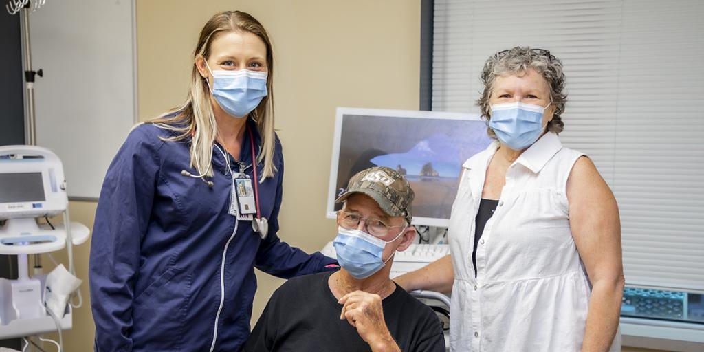 Navy Veteran Jack Pinkston (center), and wife LaVonne Pinkston (right), pose for a photo with Jessica Morton, RN, during a routine visit to the Jack C. Montgomery VA Medical Center.