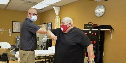 Butler VA Physical Therapist Scott Belden with a Veteran patient bumping elbows