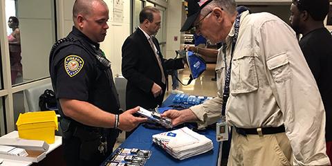 A Veteran receives a free gun lock from a VA Police Officer during a Suicide Prevention Awareness event at Charleston VAMC on Sept. 9, 2019. Photo by Erin Curran. 