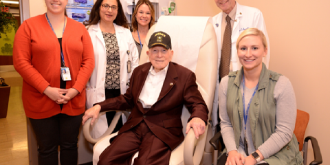 WWII Army Veteran Bennie Woolam sits next to his geriatrics health care team at the Nashville VA Medical Center.