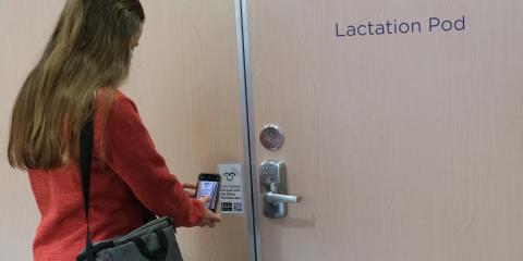 Staff using phone to enter Mamava Pod