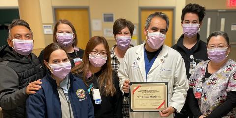 Dr. George Martinez, surrounded by supporting staff, receives the VISN 15 Good Catch Award for avoiding possible harm to a patient through his focus on ensuring Veterans receive continuous care from community providers.