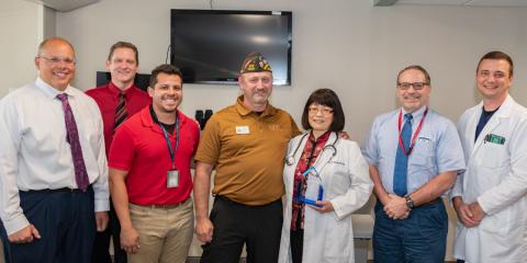 Dr. Peng poses with Erie VAMC leadership, Whole Health staff members, and Mr. Jim Brown after the award presentation. 