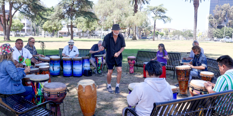 People participate in a drum circle.