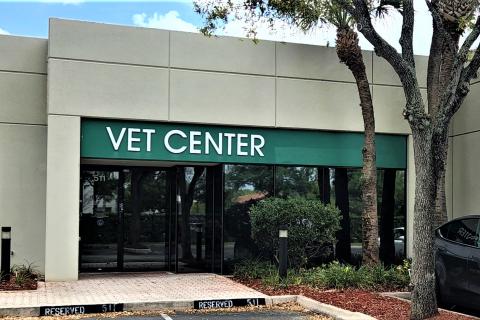 Image of the Miami Vet Center as seen standing in front of it. Green banner with white text that reads Miami Vet Center is seen.