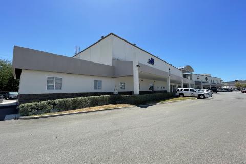 Ponce Vet Center is located within Galerias Med Centro. A two story white building with dark beige trims, and small bushes located in the front of the building.