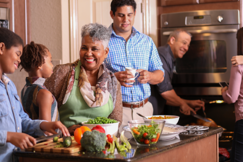 A family gathered in a kitchen at Thanksgiving