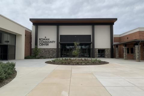 White Building with Brown trim, Rowan Community Center written on the front of the building.