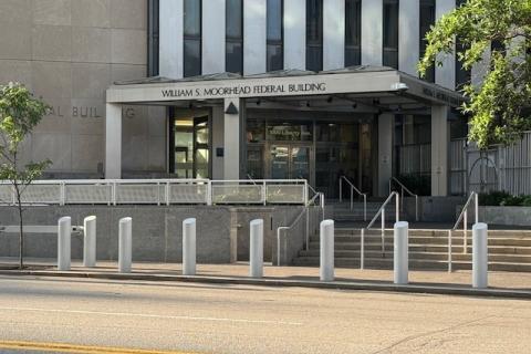 Federal Building main entrance, wheelchair ramp to the left concrete building glass doors.