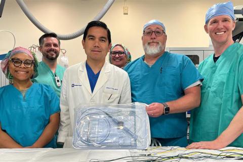 The Durham VA Electrophysiology Team poses for a group photo with an example of the VARIPULSE catheter.