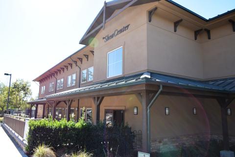 Tan two-story building of the Shea Center which is a community access point for the South Orange County Vet Center