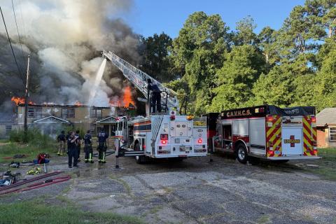 Firefighters from the CAVHCS work alongside Tuskegee Fire Department crews to battle a residential fire on July 28 in Tuskegee, Alabama.