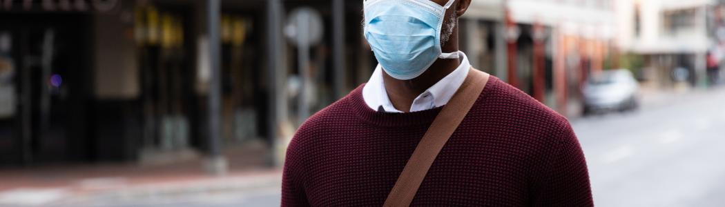 Man in street with mask on