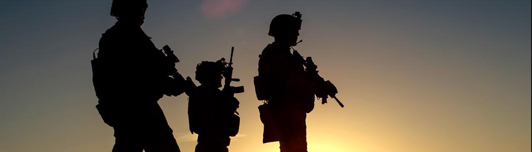 3 silhouetted military members