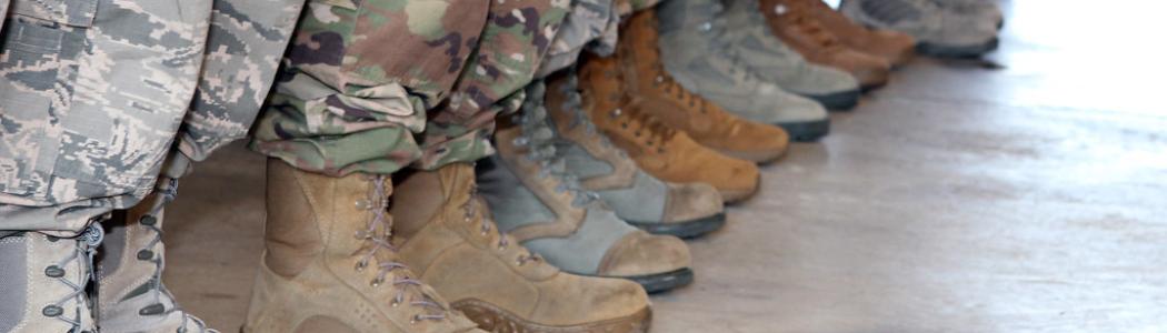 Combat boots of multiple styles of military members standing in a row