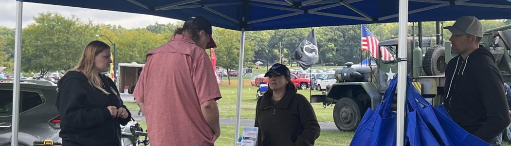 tent with veteran and employees